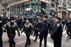 Police Officer Wilbert Mora was laid to rest 2/2/22 after being posthumously promoted to Detective First Grade, and eulogized at St. Patrick’s Cathedral. Thousands of police from all parts of the country lined Fifth Ave. as the procession carrying Detective Mora passed.  Mora was gunned down along with his partner Jason Rivera, who passed away a few days earlier. Police wait and then line up to salute as the funeral procession passes.