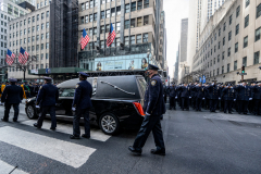 Police Officer Wilbert Mora was laid to rest 2/2/22 after being posthumously promoted to Detective First Grade, and eulogized at St. PatrickÕs Cathedral. Thousands of police from all parts of the country lined Fifth Ave. as the procession carrying Detective Mora passed.  Mora was gunned down along with his partner Jason Rivera, who passed away a few days earlier. The funeral procession heads down Fifth Ave.