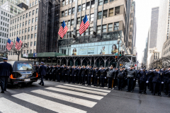 Police Officer Wilbert Mora was laid to rest 2/2/22 after being posthumously promoted to Detective First Grade, and eulogized at St. PatrickÕs Cathedral. Thousands of police from all parts of the country lined Fifth Ave. as the procession carrying Detective Mora passed.  Mora was gunned down along with his partner Jason Rivera, who passed away a few days earlier. The funeral procession heads down Fifth Ave.