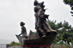 Mother Cabrini Statue at Battery Park South Cove location NYC. A rainy and foggy day. I even photographed a water spout on the Hudson River. It lasted less than a minute then disappeared.
