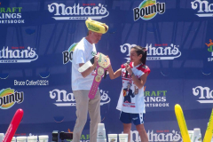 NATHAN’S FAMOUS FOURTH OF JULY HOT DOG-EATING CONTEST
 AT CONEY ISLAND’S MAIMONIDES PARK

World champion Joey Chestnut will defend his title against the world’s top eaters before a live audience at the Nathan’s Famous Fourth of July International Hot Dog-Eating Contest in Coney Island’s Maimonides Park (formerly MCU Park). 

The world’s best eating athletes  go head-to-head in the 10-minute, all-you-can-eat contest. Chestnut’s  broke his world record of 75 hot dogs and buns with 76 hot dogs. against number-two-ranked Geoffrey Esper(who has beaten Chestnut in recent events) .

In the women’s competition, Michelle Lesco won with 30 3/4hot dogs and buns  competed against world pepperoni roll-eating champion Larell Marie Mele and Sarah Rodriguez.