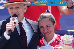George Shea and Woman's hot dog eating champion Michelle Lesco during the 2021 Nathans Famous Fourth of July International Hot Dog Eating Contest at Coney Island on 04 July 2021 in New York City.