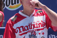 Defending Champion Joey Chestnut competes during the 2021 Nathans Famous Fourth of July International Hot Dog Eating Contest at Coney Island on 04 July 2021 in New York City. 
He broke his record by eating 76 hot dogs and buns in 10 minutes.