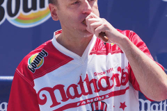 Defending Champion Joey Chestnut competes during the 2021 Nathans Famous Fourth of July International Hot Dog Eating Contest at Coney Island on 04 July 2021 in New York City. 
He broke his record by eating 76 hot dogs and buns in 10 minutes.