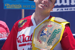 Defending Champion Joey Chestnut competes during the 2021 Nathans Famous Fourth of July International Hot Dog Eating Contest at Coney Island on 04 July 2021 in New York City. 
He broke his record by eating 76 hot dogs and buns in 10 minutes.