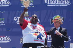 Defending Champion Joey Chestnut competes during the 2021 Nathans Famous Fourth of July International Hot Dog Eating Contest at Coney Island. 
He broke his record by eating 76 hot dogs and buns in 10 minutes.