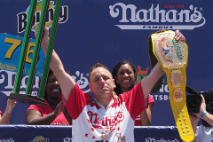 Defending Champion Joey Chestnut competes during the 2021 Nathans Famous Fourth of July International Hot Dog Eating Contest at Coney Island. 
He broke his record by eating 76 hot dogs and buns in 10 minutes.