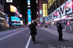 A Police Officer takes a selfie in a mostly empty Times Square in New York City that remains empty due to Covid-19 restrictions.