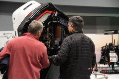 These men checking out this motor for a boat at the New York Boat Show hosted at Javits Center from 26-30 Jan 2022.
