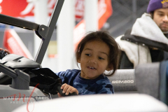 A little girl test driving the boat that is on displayed ay the New York Boat Show hosted at Javits Center from 26-30 Jan 2022.