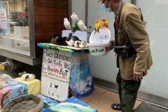 Noah The Animal Lover
He lives in NYC, retired and owns all those animals.  They are his pets.  He goes around throughout NYC and puts them on display for people to see and children to enjoy.  Petting is allowed.  All the animals are trained and 
non aggressive.  He collects voluntary donations to pay for food and associated vet cost.  His name is Noah.