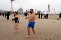 Coney Island New York: January 1 , 2021. In years past, the Coney Island Polar Bear Club would hold their annual New Year's Plunge; however, due to the Coronavirus this year, the event was canceled. In spite of this, New Year's revelers decided to hold their own non-sanctioned plunge at the beach.