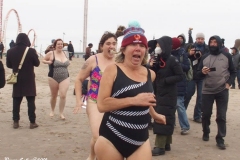 Coney Island New York: January 1 , 2021. In years past, the Coney Island Polar Bear Club would hold their annual New Year's Plunge; however, due to the Coronavirus this year, the event was canceled. In spite of this, New Year's revelers decided to hold their own non-sanctioned plunge at the beach.