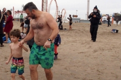 Coney Island New York: January 1 , 2021. In years past, the Coney Island Polar Bear Club would hold their annual New Year's Plunge; however, due to the Coronavirus this year, the event was canceled. In spite of this, New Year's revelers decided to hold their own non-sanctioned plunge at the beach.