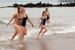 Coney Island New York: January 1 , 2021. In years past, the Coney Island Polar Bear Club would hold their annual New Year's Plunge; however, due to the Coronavirus this year, the event was canceled. In spite of this, New Year's revelers decided to hold their own non-sanctioned plunge at the beach.