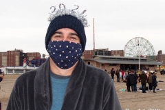 Coney Island New York: January 1 , 2021. In years past, the Coney Island Polar Bear Club would hold their annual New Year's Plunge; however, due to the Coronavirus this year, the event was canceled. In spite of this, New Year's revelers decided to hold their own non-sanctioned plunge at the beach.