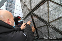 December 27, 2021  New York , Workers Install 192 New Waterford Crystals
On Times Squares New Year’s Eve Ball.The Waterford Crystal New Year’s Eve Ball is a geodesic sphere, 12 feet in diameter, and weighs 11,875 pounds. The Ball is covered with a total of 2,688 Waterford Crystal triangles that vary in size, and range in length from 4 3/4 inches to 5 3/4 inches per side. For Times Square 2022,