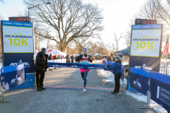 January 8, 2022: The 2022 Joe Kleinerman 10K race was held in Central Park. 4503 runners braved the 22 degree temperatures with smiles and cheers as they crossed the finish line. Here, Max Jaffe of New York, crosses the finish line as the first male finisher in 0:33:47.