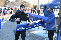 January 8, 2022: The 2022 Joe Kleinerman 10K race was held in Central Park. 4503 runners braved the 22 degree temperatures with smiles and cheers as they crossed the finish line. Here, Zackary Harris of New York, crosses the finish line as the first non-binary runner, in 0:40:59.