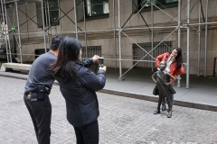 December 13,2020  Wall Street in front of the New York Stock Exchange residents and tourists visit the Fearless Girl statue and take photographs by the Stock exchange Christmas tree.
