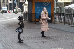 December 13,2020  Wall Street in front of the New York Stock Exchange residents and tourists visit the Fearless Girl statue and take photographs by the Stock exchange Christmas tree.