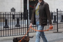 December 13,2020  Wall Street in front of the New York Stock Exchange residents and tourists visit the Fearless Girl statue and take photographs by the Stock exchange Christmas tree.