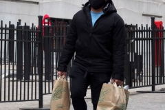 December 13,2020  Wall Street in front of the New York Stock Exchange residents and tourists visit the Fearless Girl statue and take photographs by the Stock exchange Christmas tree.