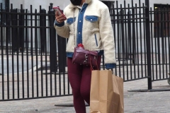 December 13,2020  Wall Street in front of the New York Stock Exchange residents and tourists visit the Fearless Girl statue and take photographs by the Stock exchange Christmas tree.