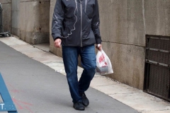 December 13,2020  Wall Street in front of the New York Stock Exchange residents and tourists visit the Fearless Girl statue and take photographs by the Stock exchange Christmas tree.
