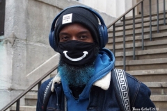 December 13,2020  Wall Street in front of the New York Stock Exchange residents and tourists visit the Fearless Girl statue and take photographs by the Stock exchange Christmas tree.