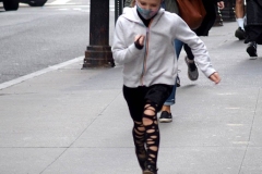 December 13,2020  Wall Street in front of the New York Stock Exchange residents and tourists visit the Fearless Girl statue and take photographs by the Stock exchange Christmas tree.