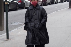 December 13,2020  Wall Street in front of the New York Stock Exchange residents and tourists visit the Fearless Girl statue and take photographs by the Stock exchange Christmas tree.