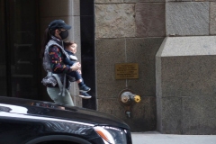 December 13,2020  Wall Street in front of the New York Stock Exchange residents and tourists visit the Fearless Girl statue and take photographs by the Stock exchange Christmas tree.