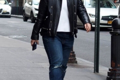 December 13,2020  Wall Street in front of the New York Stock Exchange residents and tourists visit the Fearless Girl statue and take photographs by the Stock exchange Christmas tree.