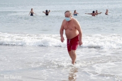 December 13,2020 Coney Island Polar Bear Club enjoys beautiful weather while people stroll the boardwalk and enjoy the sunny weather before the predicted snow storm to hit the East Coast on Wednesday.