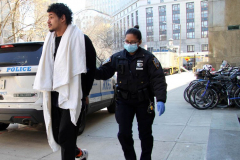 February 20, 2022  New York, 
Police Officers from the 1st precinct walk a suspect into the  Manhattan Criminal Courthouse for arraignment.