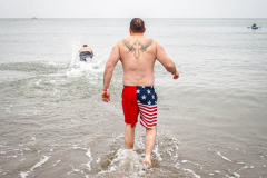 The Polar Bear Plunge commenced after a two year hiatus. An overcast and chilly day, spectators and participants took to the beach to keep on the ol’ tradition that kick starts many peoples’ year with a shock awakening of the senses. Brooklyn, NYC, NY. 01.01.22 (C) Bianca Otero