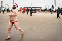 The Polar Bear Plunge commenced after a two year hiatus. An overcast and chilly day, spectators and participants took to the beach to keep on the ol’ tradition that kick starts many peoples’ year with a shock awakening of the senses. Brooklyn, NYC, NY. 01.01.22 (C) Bianca Otero