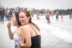 The Polar Bear Plunge commenced after a two year hiatus. An overcast and chilly day, spectators and participants took to the beach to keep on the ol’ tradition that kick starts many peoples’ year with a shock awakening of the senses. Brooklyn, NYC, NY. 01.01.22 (C) Bianca Otero