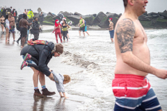 The Polar Bear Plunge commenced after a two year hiatus. An overcast and chilly day, spectators and participants took to the beach to keep on the ol’ tradition that kick starts many peoples’ year with a shock awakening of the senses. Brooklyn, NYC, NY. 01.01.22 (C) Bianca Otero