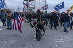 Washington, DC - January 6, 2021: Trump supporter prays in front of Capitol building where pro-Trump supporters riot and breached the Capitol