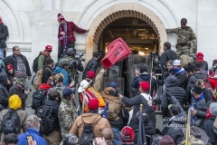 Washington, DC - January 6, 2021: Rioters clash with police trying to enter Capitol building through the front doors