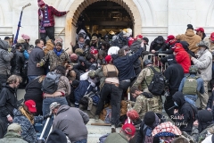 Washington, DC - January 6, 2021: Rioters clash with police trying to enter Capitol building through the front doors