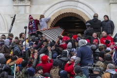Washington, DC - January 6, 2021: Rioters clash with police trying to enter Capitol building through the front doors