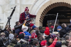 Washington, DC - January 6, 2021: Rioters clash with police trying to enter Capitol building through the front doors