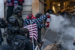 Washington, DC - January 6, 2021: Pro-Trump protester uses tear gas against police during rally around at Capitol building when they tried to break in through front doors