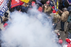 Washington, DC - January 6, 2021: Smoke rises after explosure police used pepper-spray ball gun against Pro-Trump protesters rally around Capitol building before they breached it and overrun it