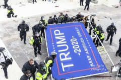 Washington, DC - January 6, 2021: Police dismantle Pro-Trump huge flag display as protesters rally around Capitol building before they breached it and overrun it