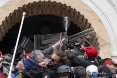Washington, DC - January 6, 2021: Pro-Trump protesters seen using tear gas against police as they try to enter Capitol building through front doors