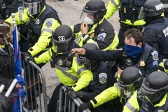 Washington, DC - January 6, 2021: Police defend Capitol building against Pro-Trump protesters by using papper spray